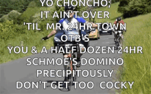 a man riding a bike down a road with a caption that says yo choncho it ain t over
