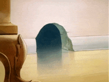 a cartoon scene with a mouse hole in the wall