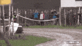 a group of people watching a race with the name clowilli96 on the bottom right