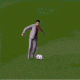 a man in a suit is dancing on a stage in front of a crowd on a television screen .