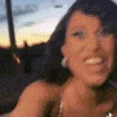 a woman is smiling in a blurry photo
