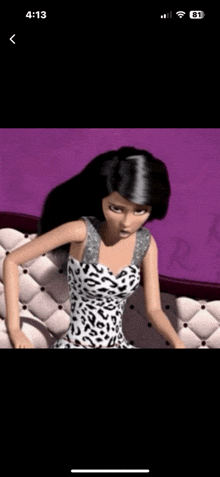 a barbie doll is sitting on a couch wearing a leopard print dress