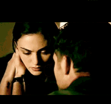 a man and a woman are hugging and kissing each other .