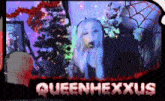 a picture of a girl singing in front of a christmas tree with the name queenhexxus on the bottom