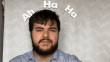 a man with a beard and mustache is making a funny face while sitting on a bed .