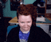 a woman with red hair is sitting in front of a desk with a sign that says n7