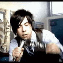 a man in a suit and tie is holding a microphone and a fork