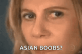 a close up of a woman 's face with the words asian boobs .