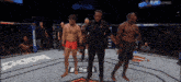 a man in red shorts stands in a boxing ring with a bud light banner in the background