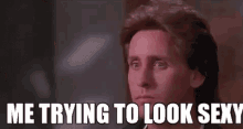 a man is looking at the camera with the words `` me trying to look sexy '' written above him .