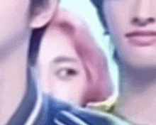 a man and a woman are standing next to each other . the woman has pink hair and the man has black hair .