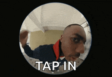 a man is looking through a peephole and the words tap in are on the screen