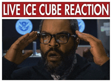 a man wearing glasses holds his hands to his head in front of a live ice cube reaction sign