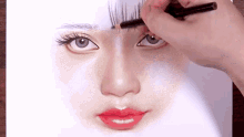 a person is drawing a woman 's face with a pencil on a piece of paper