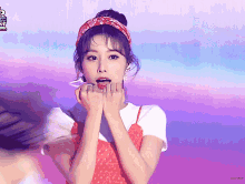 a woman wearing a red bandana and a red dress with a purple background