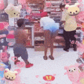 a man wearing a shirt that says titles stands in a store surrounded by stuffed animals