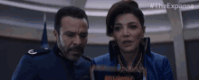 a man and a woman are looking at something with the hashtag #theexpanse on the bottom