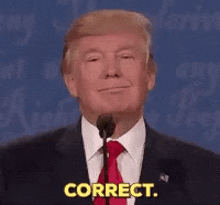 donald trump is giving a speech in front of a microphone and saying `` correct '' .