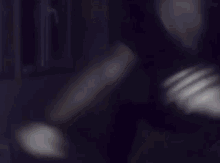 a blurry picture of a person 's face with a dark background