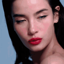 a close up of a woman with red lipstick on her lips