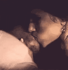 a woman is kissing a man 's penis in a sepia tone photo .