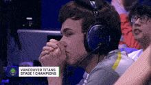 a man wearing headphones with the words vancouver titans stage 1 champions
