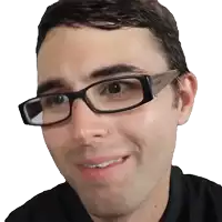 a man wearing glasses and a black shirt smiles
