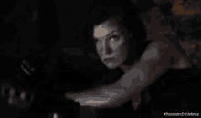 a close up of a woman 's face with a light coming out of her hair .