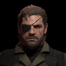 a man with a beard and an eye patch is wearing sunglasses and a vest .