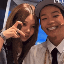 a man and a woman are posing for a picture and the man is wearing a white shirt and tie