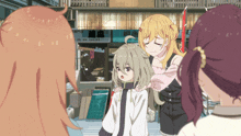 a group of anime girls are standing in front of a store with chinese writing on the front