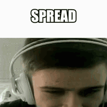 a man wearing headphones with the words `` spread '' written on it .