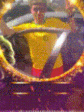 a blurry picture of a man wearing a yellow shirt and red shorts