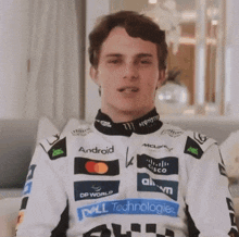 a man wearing a white jacket with logos for dell technologies and monster energy on it