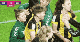 a group of soccer players are hugging each other on a field with the scoreboard showing sms 1-3 gks 63:08
