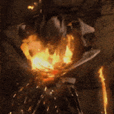 a person is standing in front of a fire with a lot of flames coming out of it .