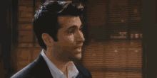 a man in a suit and white shirt is looking to the side