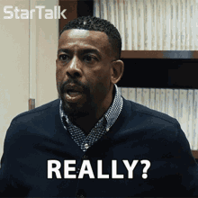 a man with a beard says really in front of a startalk logo