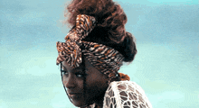 a woman wearing a zebra print head scarf