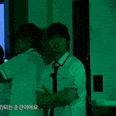 a man in a white shirt is standing in front of a green light