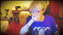 a person wearing a purple shirt with a picture of three faces on it