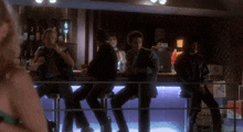 a blurred image of people sitting at a bar with a sign that says " no smoking " on it