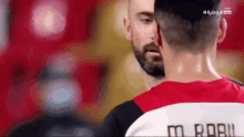 a man wearing a red shirt with the number 8 on the back