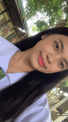 a girl in a school uniform taking a selfie