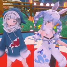 a girl in a shark hoodie and a girl in a bunny costume are standing next to each other .