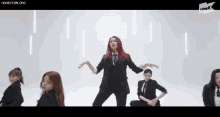 a group of women in suits and ties are dancing in front of a white background ..
