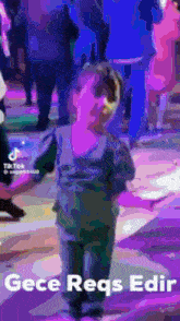 a little boy is dancing in a crowd with the words gece reqs edr written below him