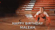 a volleyball player is doing push ups on a basketball court while saying happy birthday maleah .