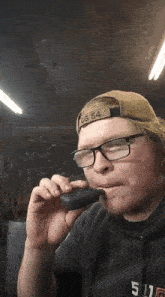 a man wearing glasses and a hat that says gg 54