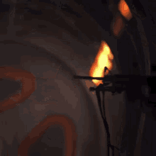 a close up of a fire coming out of a pipe in a dark room
